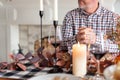 Man sitting at holiday dinner table with clasped hands Royalty Free Stock Photo