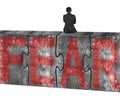 Man sitting on huge concrete puzzles with red fear word