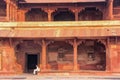 Man sitting in the inner courtyard of Jodh Bai Palace in Fatehpur Sikri, Uttar Pradesh, India Royalty Free Stock Photo