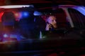 man sitting inside a car and talking on the phone after being stopped by police
