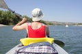 Man sitting in kayak and paddling, active summer vacation on river Royalty Free Stock Photo