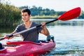 Man sitting in kayak paddling on lake Royalty Free Stock Photo