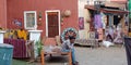 A man sitting on khatiya outside village home