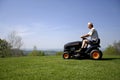 Man sitting on a lawnmower Royalty Free Stock Photo