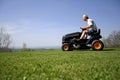 Man sitting on a lawnmower Royalty Free Stock Photo