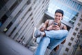 Happy man listening to music with headphones from a smartphone on the street. Royalty Free Stock Photo