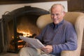 Man sitting in living room by fireplace Royalty Free Stock Photo