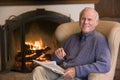 Man sitting in living room by fireplace Royalty Free Stock Photo