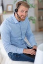 man sitting in living room at home wearing headset Royalty Free Stock Photo