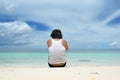 Man sitting lonely on beach Royalty Free Stock Photo