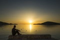 Man sitting looking at beautiful sunset over the sea in Croatia Europe