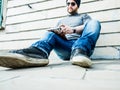 Man sitting, looking at his notebook and writing something - close low angle shot Royalty Free Stock Photo