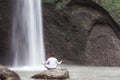 Man sitting in meditation yoga on rock at waterfall Tibumana Royalty Free Stock Photo