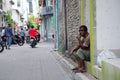 Man sitting near entrance of his house