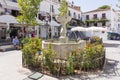 Man sitting near fountain. The town is a popular expat and tourist destination