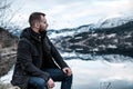 Man sitting near Hardangerfjord, Norway.