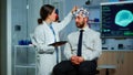 Man sitting on neurological chair with brainwave scanning headset