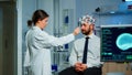 Man sitting on neurological chair with brainwave scanning headset