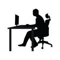 Man sitting on office chair at table and working