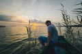 Man sitting in the old boat thinking Royalty Free Stock Photo