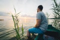 Man sitting in the old boat thinking Royalty Free Stock Photo