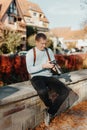 Man Sitting in Old European City And Holding Photo Camera. Contemporary Stylish Blogger And Photographer. Handsome man Royalty Free Stock Photo