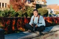 Man Sitting in Old European City And Holding Photo Camera. Contemporary Stylish Blogger And Photographer. Handsome man