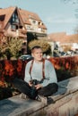 Man Sitting in Old European City And Holding Photo Camera. Contemporary Stylish Blogger And Photographer. Handsome man Royalty Free Stock Photo