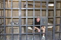 Man Sitting in Old Time jail