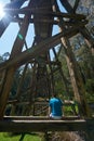 Man sitting on old trestle bridge