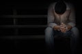 A man Sitting at an old wooden stairs and a sad Royalty Free Stock Photo