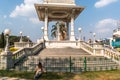 A man sitting outside a statue of Babasaheb Ambedkar