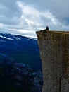 Man sitting on Pulpit Rock Preikestolen Norway