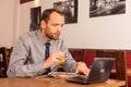 Man sitting in restaurant with laptop,and phone Royalty Free Stock Photo