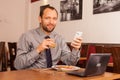 Man sitting in restaurant with laptop,and phone Royalty Free Stock Photo