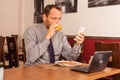 Man sitting in restaurant with laptop,and phone Royalty Free Stock Photo