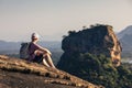 Man sitting on rock and looking at landscape