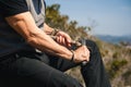 Man sitting on a rock in the nature carving a wooden stick Royalty Free Stock Photo