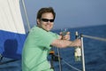 Man sitting on sailboat, drinking white wine