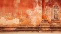 a man sitting on a skateboard in front of an orange wall