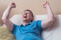 Man sitting on sofa. Excited Man Celebrate Watching Sports On Television