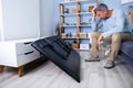 Man Sitting On Sofa In Front Fallen Television Royalty Free Stock Photo