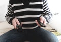 Man sitting on sofa holding remote control in each hand Royalty Free Stock Photo