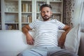 Man sitting on sofa in living room Royalty Free Stock Photo