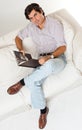 Man sitting on a sofa reading a book Royalty Free Stock Photo