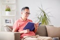 Man sitting on sofa and reading book at home Royalty Free Stock Photo