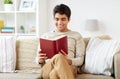 Man sitting on sofa and reading book at home Royalty Free Stock Photo