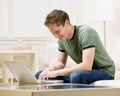 Man sitting on sofa typing on laptop Royalty Free Stock Photo