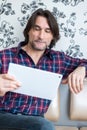 Man sitting in sofa using electronic tablet Royalty Free Stock Photo