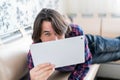 Man sitting in sofa using electronic tablet Royalty Free Stock Photo